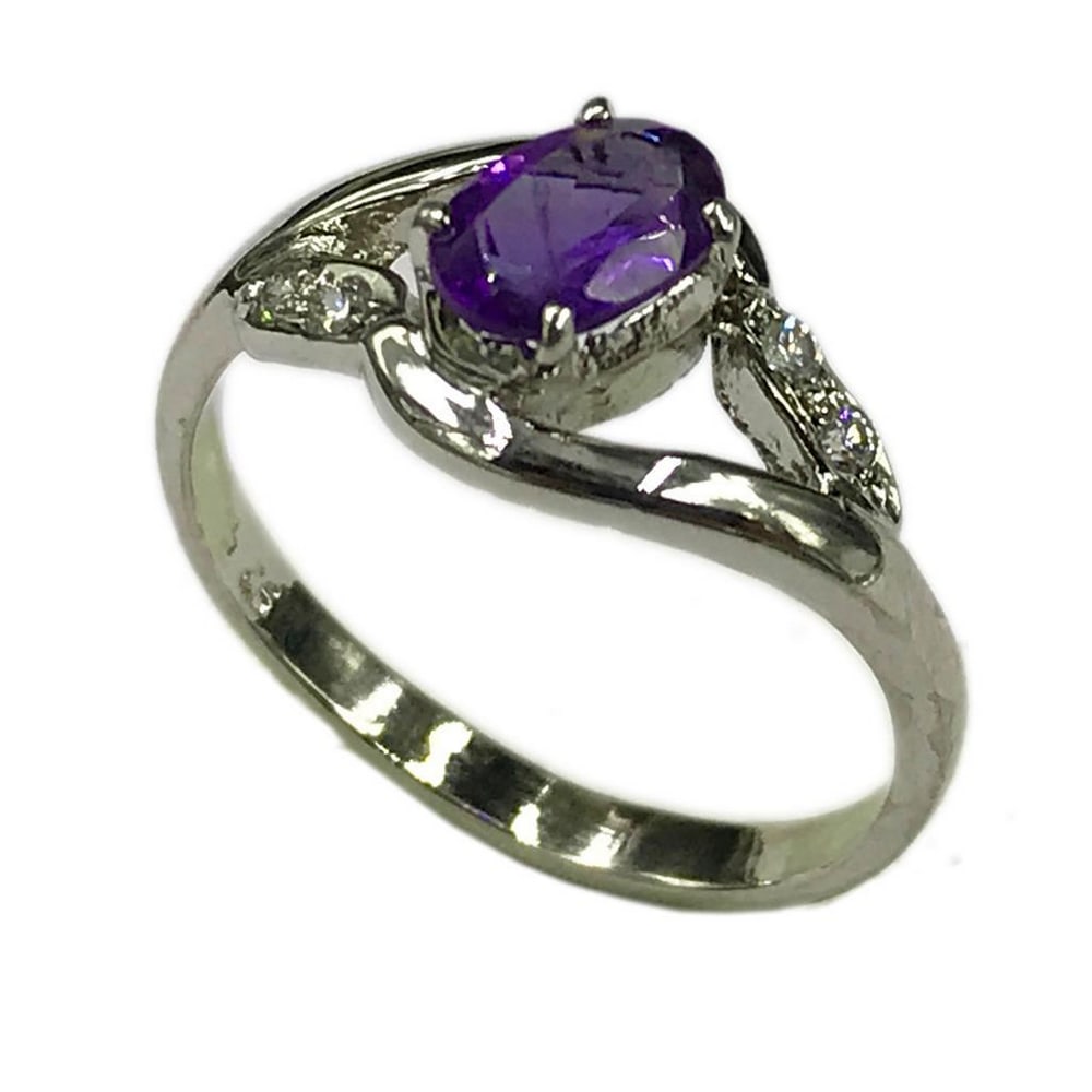 925 Sterling Silver Ring with Austrian Crystals and a Beautiful Amethyst Gemstone: 925 Sterling Silver Ring with Austrian Crystals and a Beautiful Amethyst Gemstone. The crystals represent purification and connection to spiritual and divine beings. The meaning of amethyst is attache