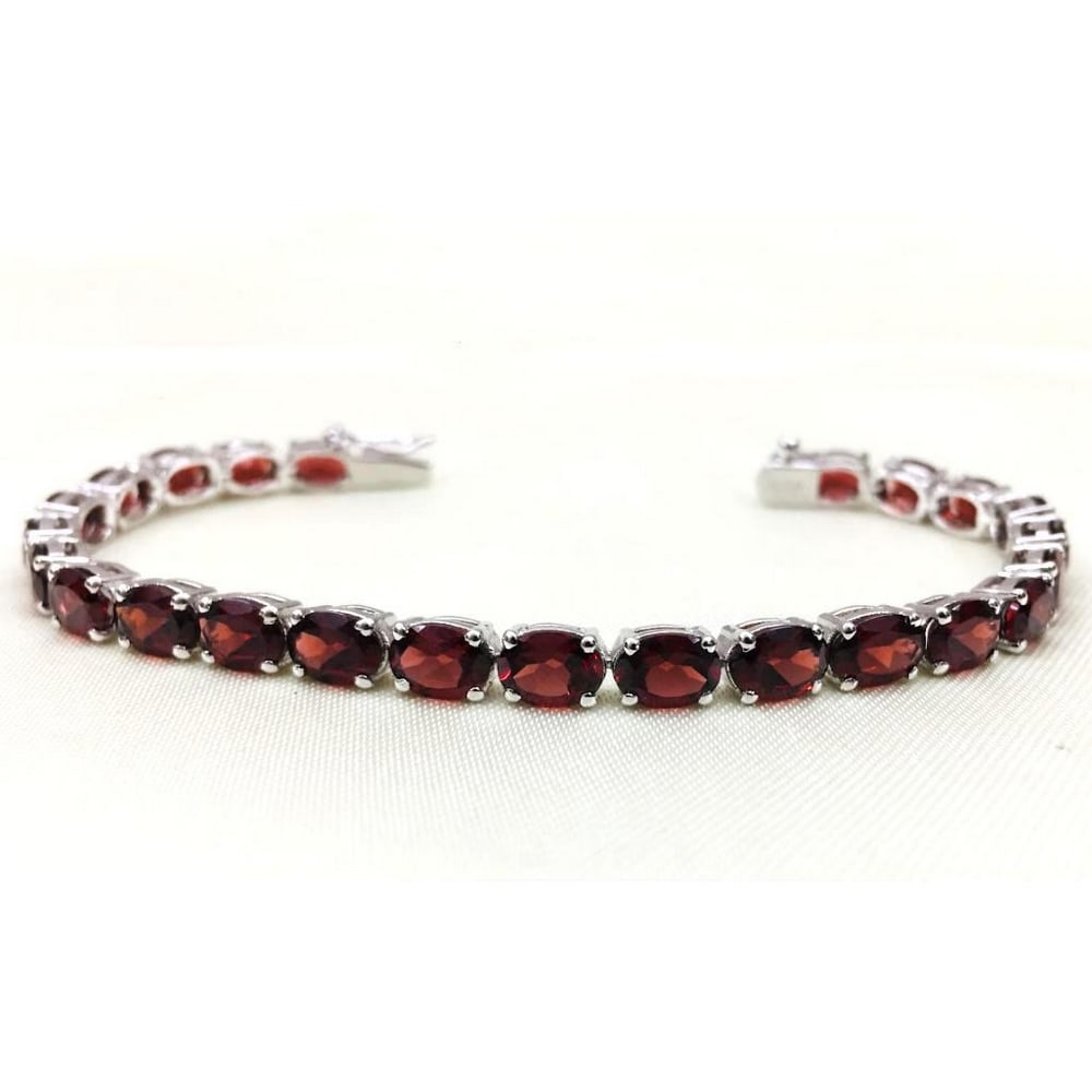 925 Sterling Silver Bracelet Studded with Garnet Faceted Oval Gems: 925 Sterling Silver Bracelet Studded with Garnet Faceted Oval Gems Garnet is known for revitalizing, purifying, and balancing energy, bringing serenity or passion as appropriate. It inspires love and