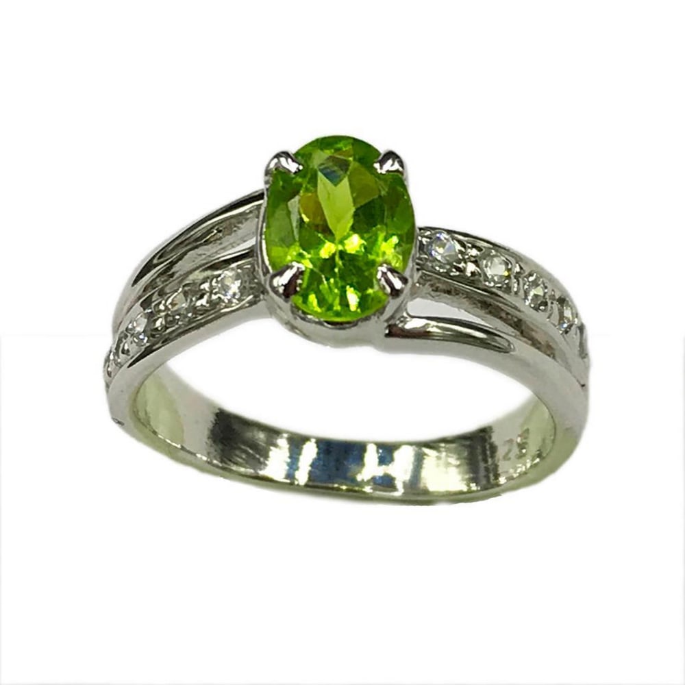 925 Sterling Silver Ring with Austrian Crystal Double Band and a Peridot Gemstone in a Halo Setting: 925 Sterling Silver Ring with Austrian Crystal Double Band and a Peridot Gemstone in a Halo Setting. Peridot gemstones are associated with harmony, peacefulness, good health, and restful sleep. This