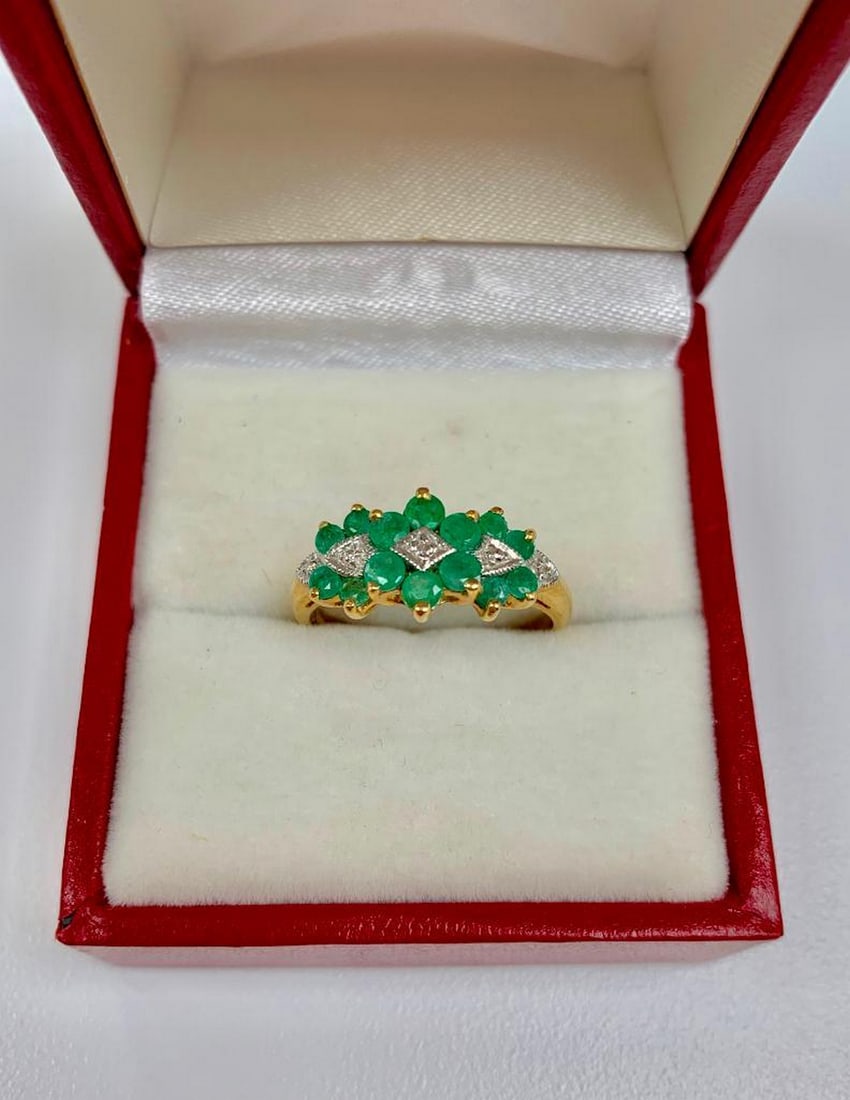 Detailed Ladies Size 7, 10k Gold, Emerald and Diamond Ring: This ring is completed with seven 0.04ct round cut emerald stones, and is mediated by four small, round cut diamonds. All set in a lustrous 10k gold ring. Please view photos for further details.