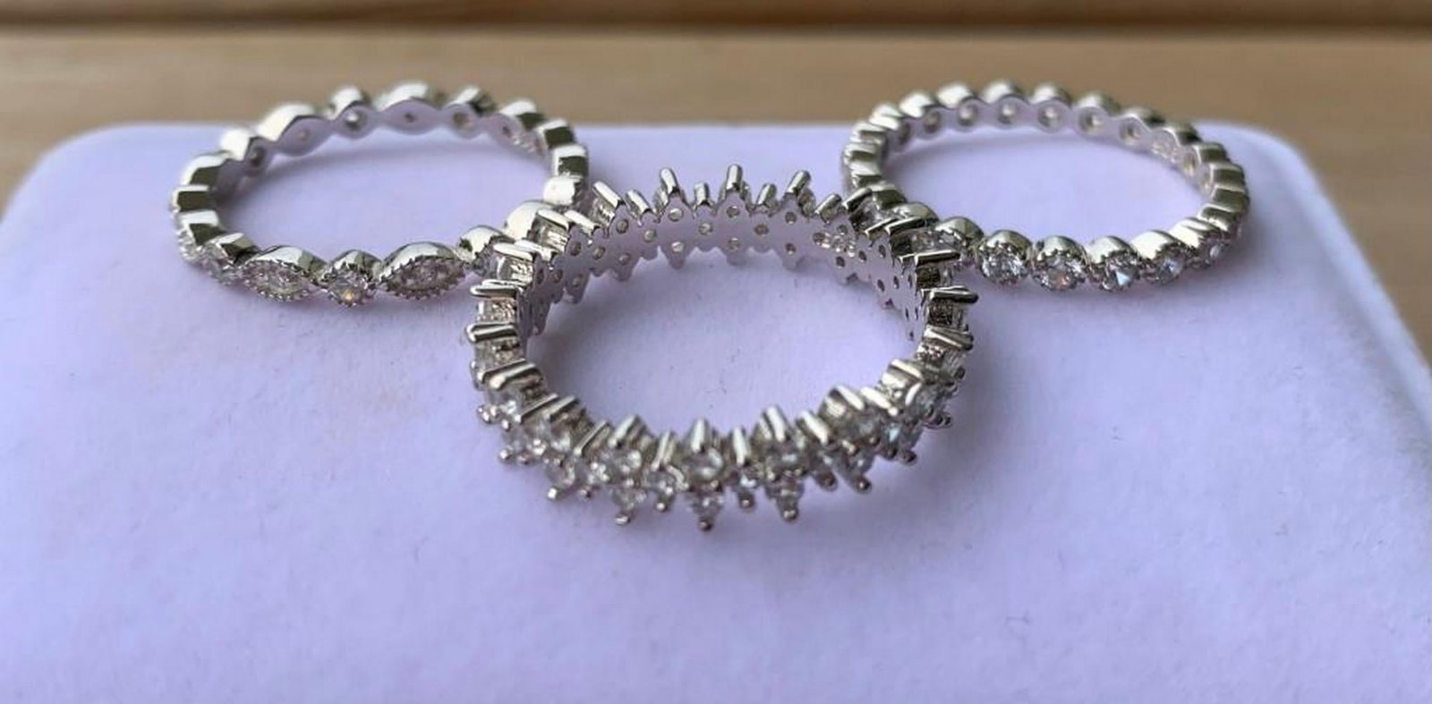 Set of 3 Silver-Tone Bands with Sparkling Floral & Geometric Accents: Set of 3 Silver-Tone Bands with Sparkling Floral & Geometric Accents Add a touch of charm and versatility to your jewelry collection with this stunning set of three silver-tone ring bands. Each ba