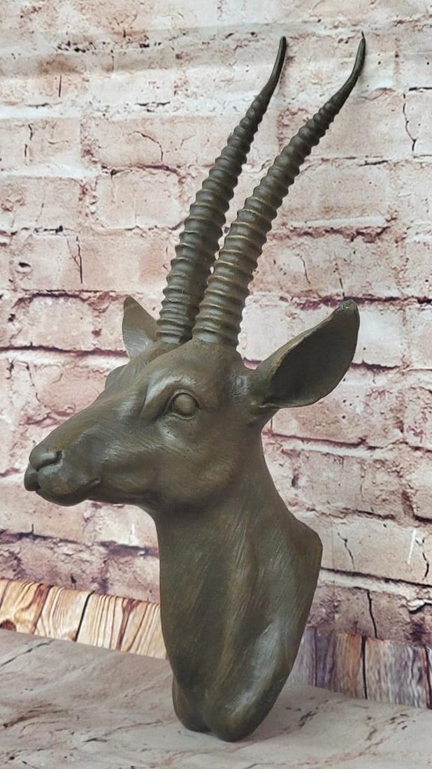 Bronze Gazelle Head Wall Mount Sculpture - 16" x 8": Bronze Gazelle Head Wall Mount Sculpture - 16" x 8" Bronze wall-mounted sculpture depicting a gazelle head with elongated horns. Handcrafted using the traditional lost wax method, featuring a 