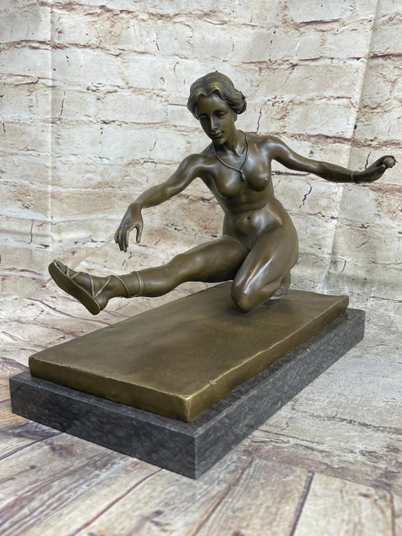 Jean Patoue Inspired Bronze Ballerina Sculpture - 10" x 11": Jean Patoue Inspired Bronze Ballerina Sculpture - 10" x 11" This bronze sculpture depicts a nude ballerina captured in a graceful stretching pose. Her body bends fluidly toward the ground as o