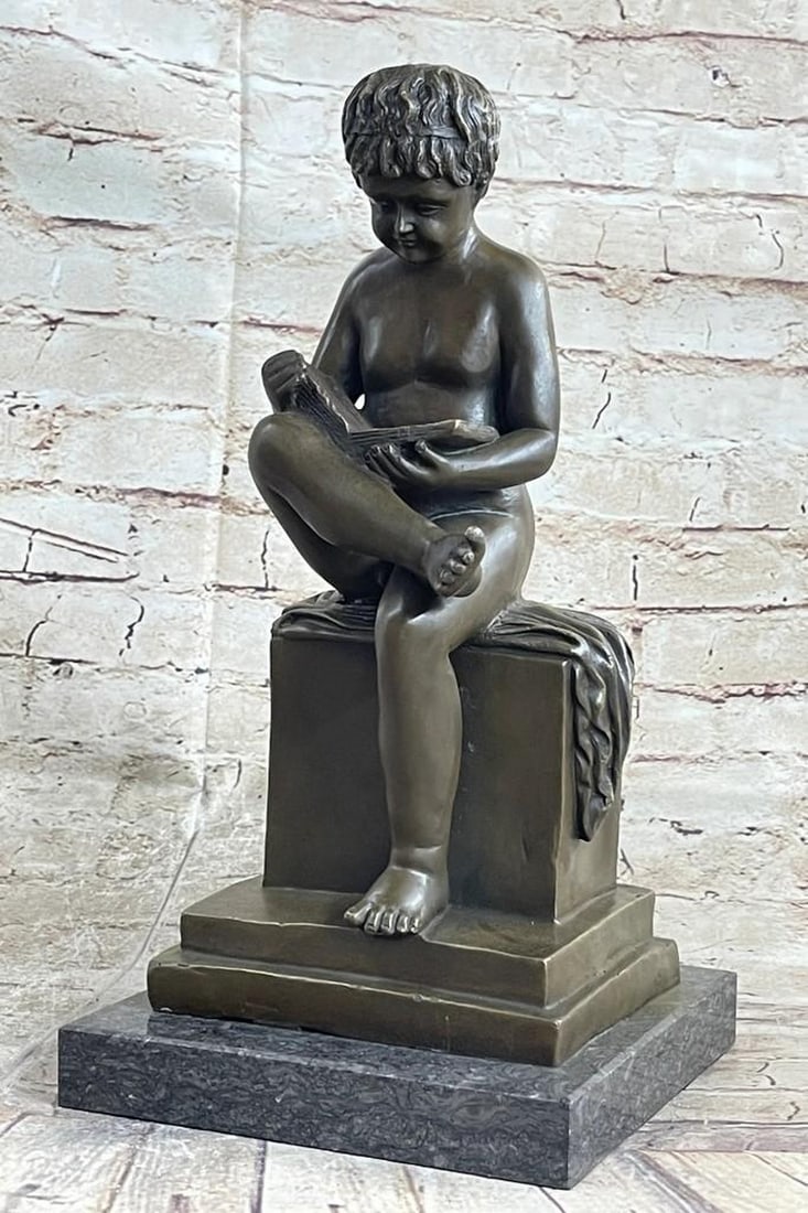 Young Boy Reading Bronze Sculpture: Young Boy Reading Bronze Sculpture What a joy it is to see young Boy enjoy a book! This sweet little boy stands smartly with a book on her lap. He is entranced in the novel that is coming to life in h