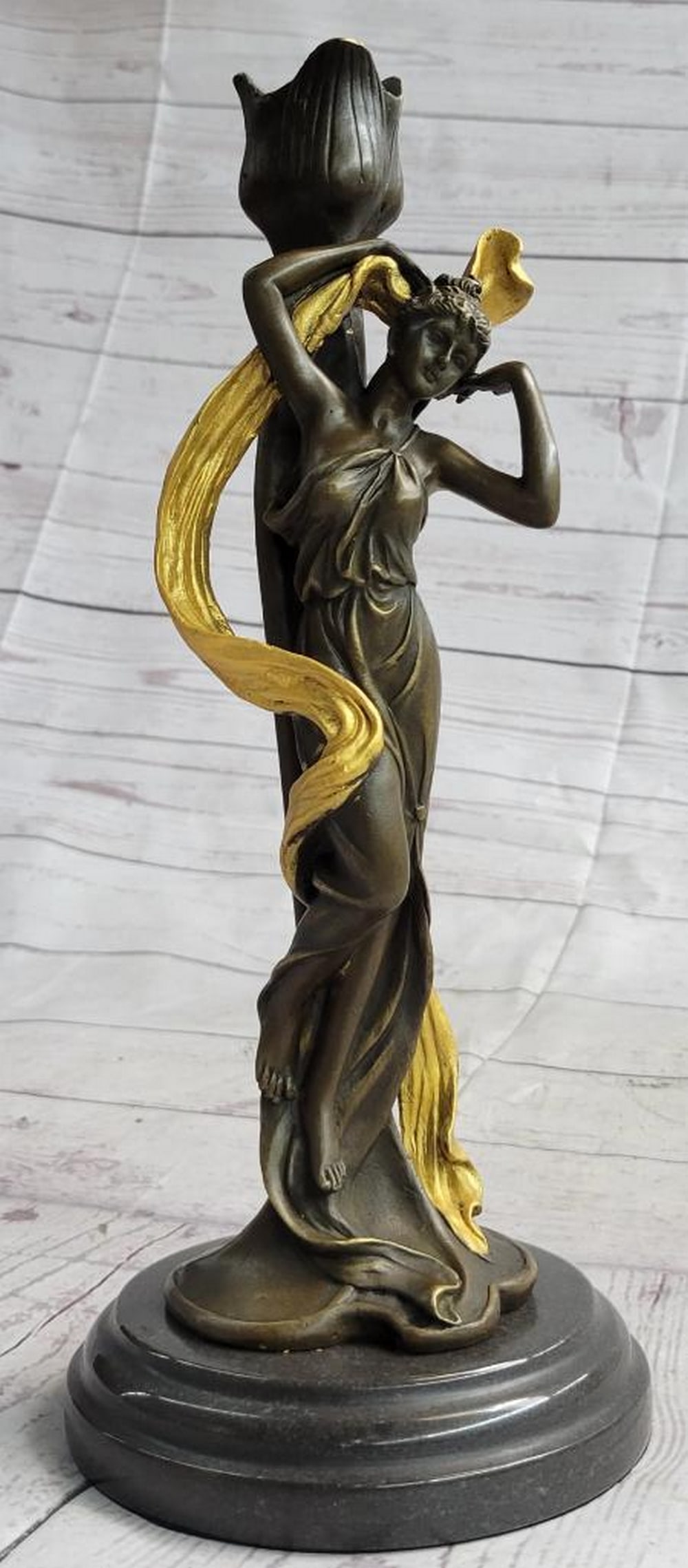 Gold Patina Woman Bronze Sculpture: Gold Patina Woman Bronze Sculpture This candelabra is a superb reproduction from the past. Made with solid bronze, hand-painted and antiqued, this candelabra features flowing lines and rich details. T