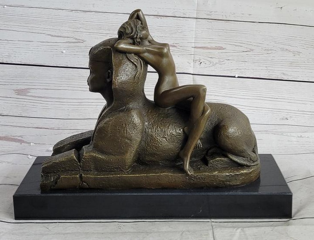 Sphinx and Nude Female Bronze Statue: Sphinx and Nude Female Bronze Statue This exceptional French Art Nouveau figure by T. Herlinger calls upon classical influences. This stunning work captures a languid beauty lounging against a noseles
