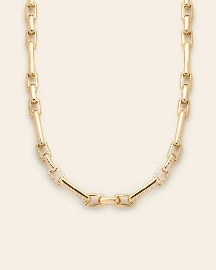 Golden Radiance Chain Necklace: Golden Radiance Chain Necklace All eyes on her. This chain shines effortlessly on its own or layered with your favorite pieces. Crafted in 14k gold plated over brass, it features alternating smaller a