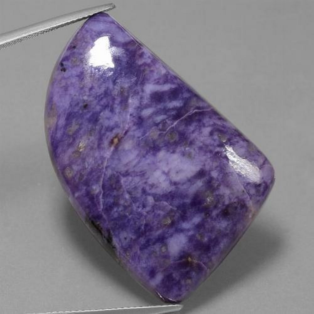 48.2ct Violet "Purple Shader" Charoite Gem Stone: 48.2ct Violet Charoite Gemstone This beautiful violet gemstone is an overall stress buster, giving off serene energy this Charoite is overall great for the mind and body health. Size: 35.2 x 23.9 x