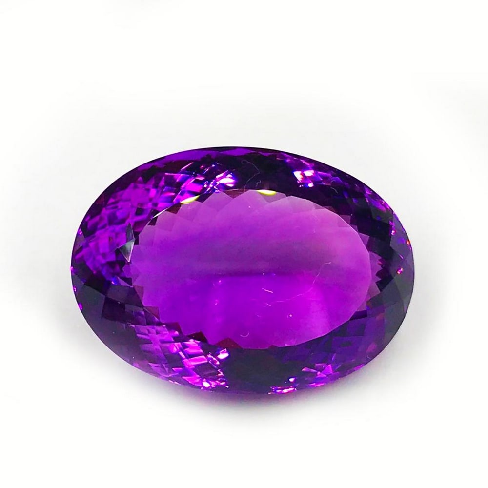 95.72ct Faceted Amethyst Oval Gemstone: Faceted Amethyst Oval With a deep and beautiful shade of purple, this gem is absolutely mesmerizing Size- 35.3 x 25.2 mm, Weight- 95.72 ct View photos for further details.