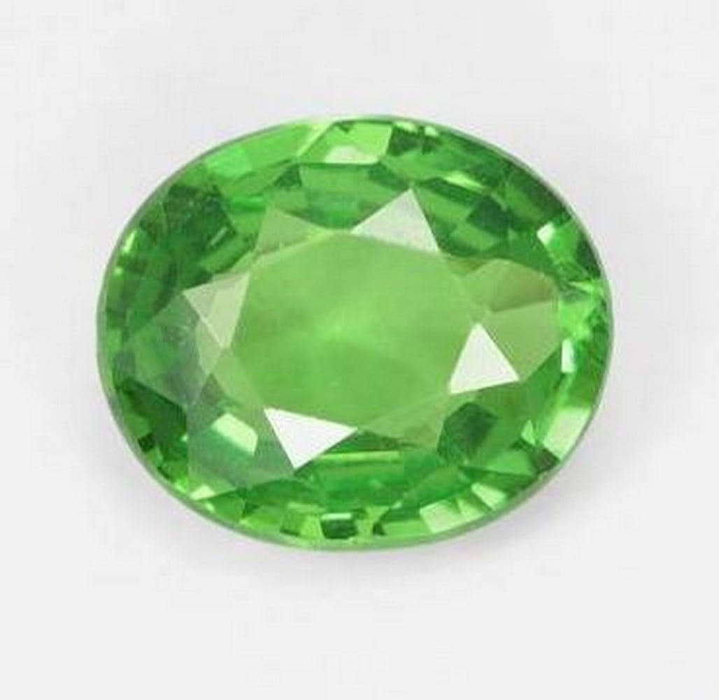 0.69 ct Oval Cut Shamrock Medium Green Tsavorite Garnet Gemstone: 0.69 ct Oval Cut Shamrock Medium Green Tsavorite Garnet Gemstone Introducing our enchanting 0.69 ct Oval Cut Shamrock Medium Green Tsavorite Garnet Gemstone—a verdant masterpiece that embodies the