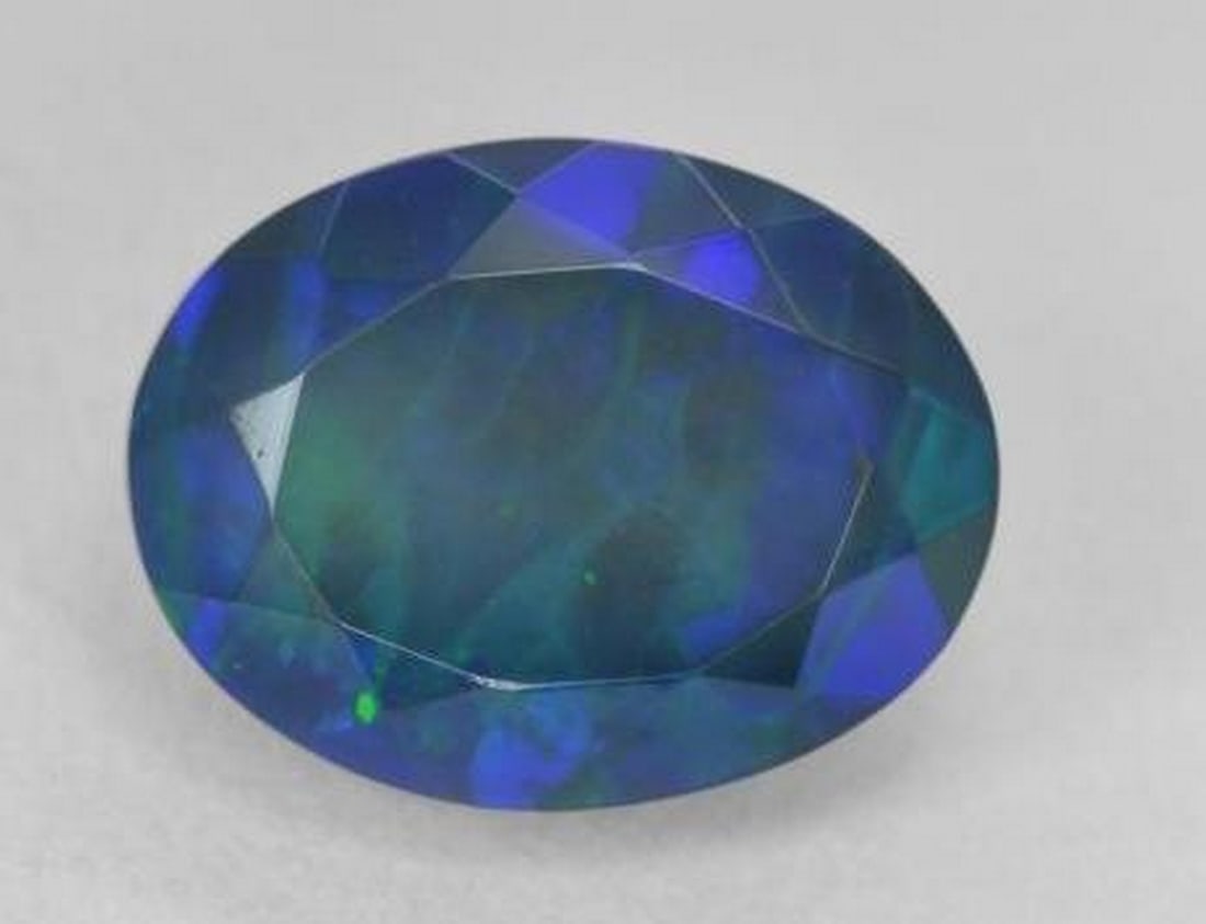 3.52 ct Oval Cut Faceted Celestial Galactic Black Opal Gemstone: 3.52 ct Oval Cut Faceted Celestial Galactic Black Opal Gemstone Embark on a cosmic journey with the Oval Cut Faceted Celestial Galactic Opal Gemstone—a mesmerizing celestial treasure that