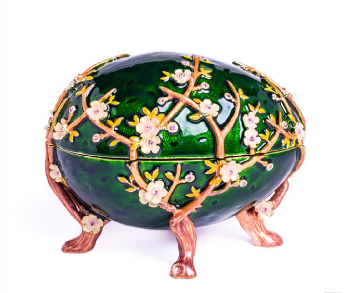 Blooming Orchard Faberge Egg: Blooming Orchard Faberge Egg Elevate your surroundings with the Blooming Orchard Faberge Egg, a symbol of nature's exquisite beauty plated with 24K Gold. Crafted by skilled artisans, each delicate