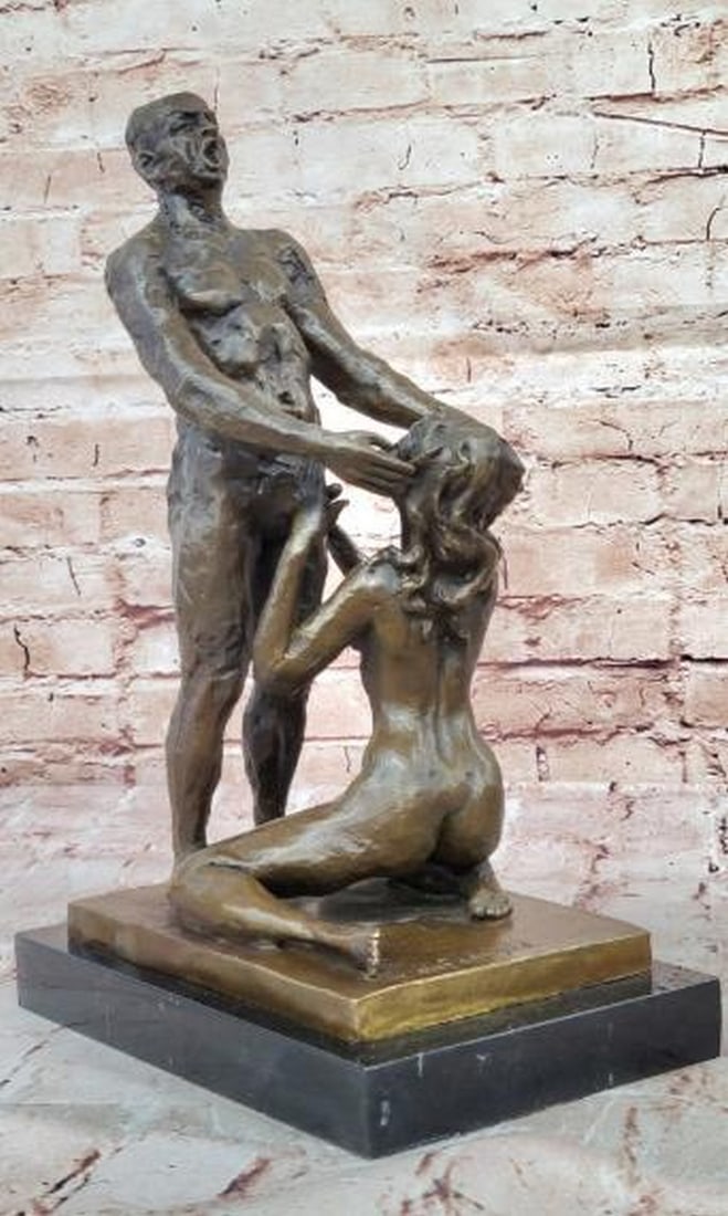 Bronze Sculpture of Love, Strength, and Vulnerability: Bronze Sculpture of Love, Strength, and Vulnerability This striking bronze sculpture bearing the signature of artist Olef Odegaard captures the profound intimacy between a standing male figure and a k