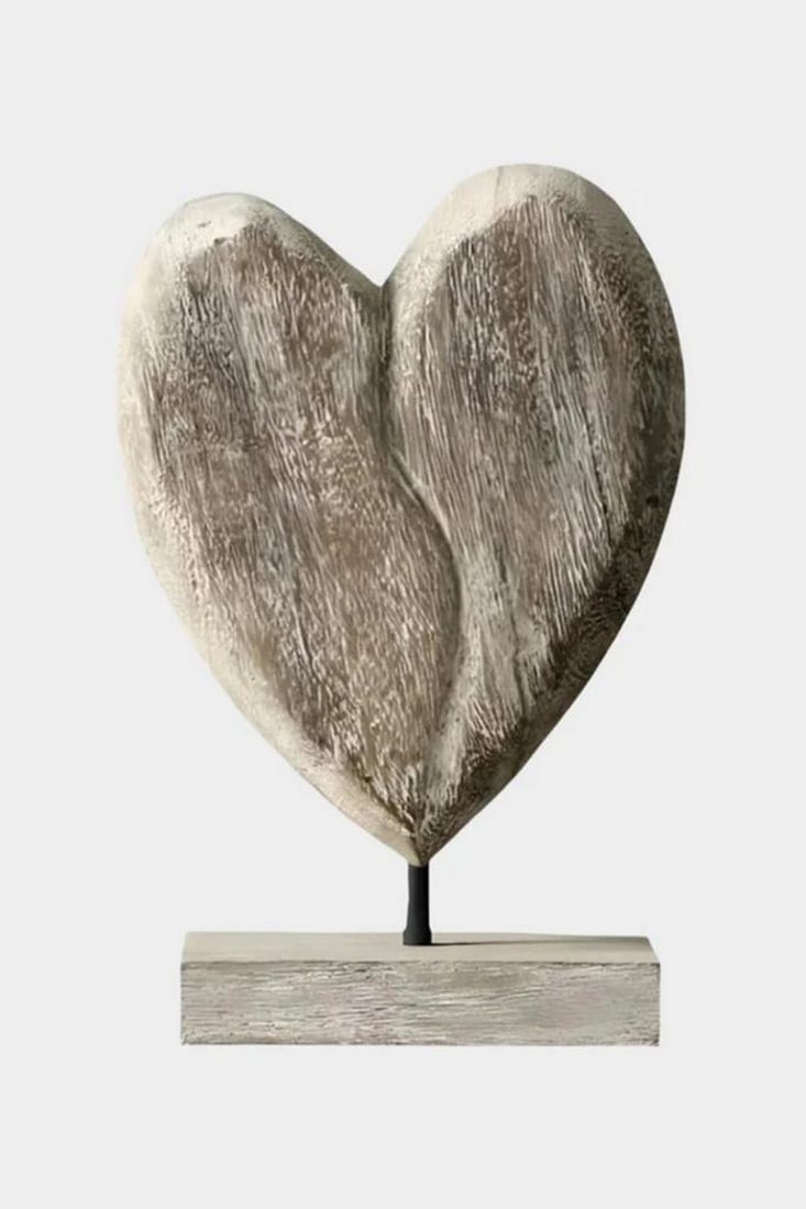 "Worn Heart of the Wild" Wooden Sculpture: "Worn Heart of the Wild" Wooden Sculpture A beautifully imperfect heart carved from wood, this sculpture evokes the raw warmth of nature and the resilience of love. Its asymmetry and distresse