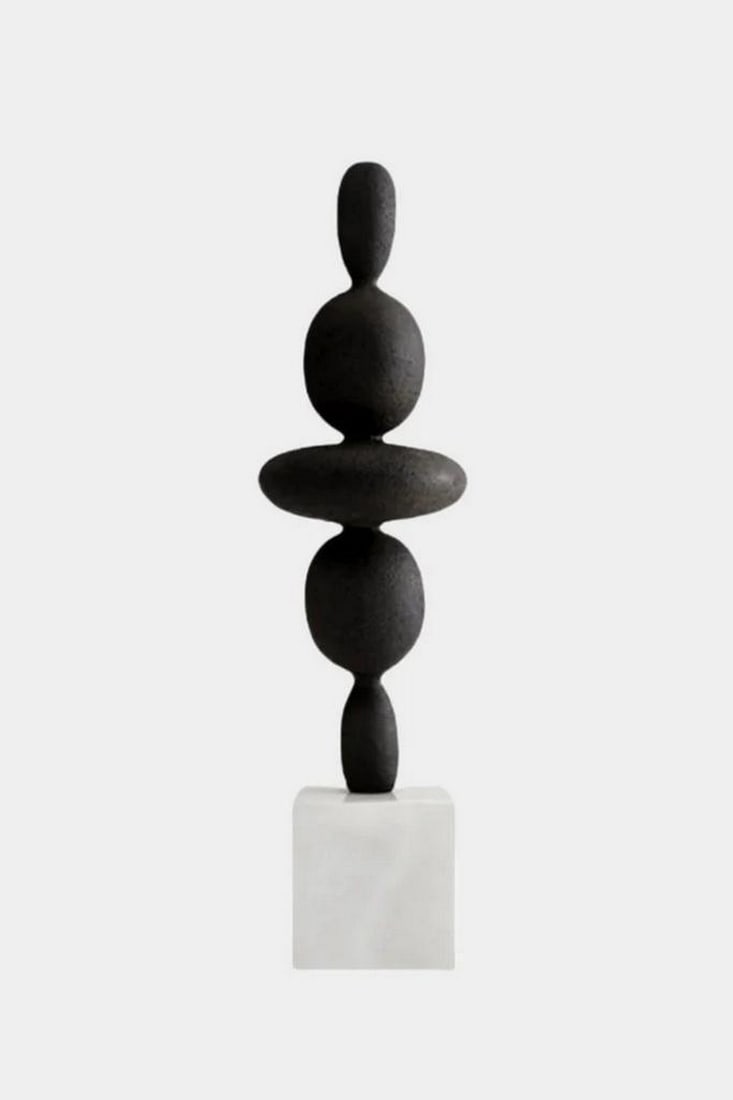 Abstract Stacked Wood Sculpture on White Base: Abstract Stacked Wood Sculpture on White Base A modern sculptural piece crafted from smooth, black-painted wood. It features a vertical stack of rounded, organically-shaped forms, each carefully balan