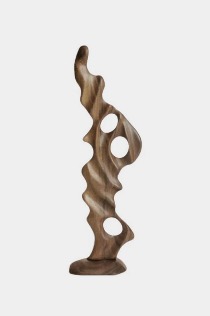 Echoes of the Forest Hand-Carved Sculpture: Echoes of the Forest Hand-Carved Sculpture Shaped by hand from richly grained hardwood, this sculpture evokes the natural rhythms of forest growth—fluid, wild, and harmonious. Its twin hollow