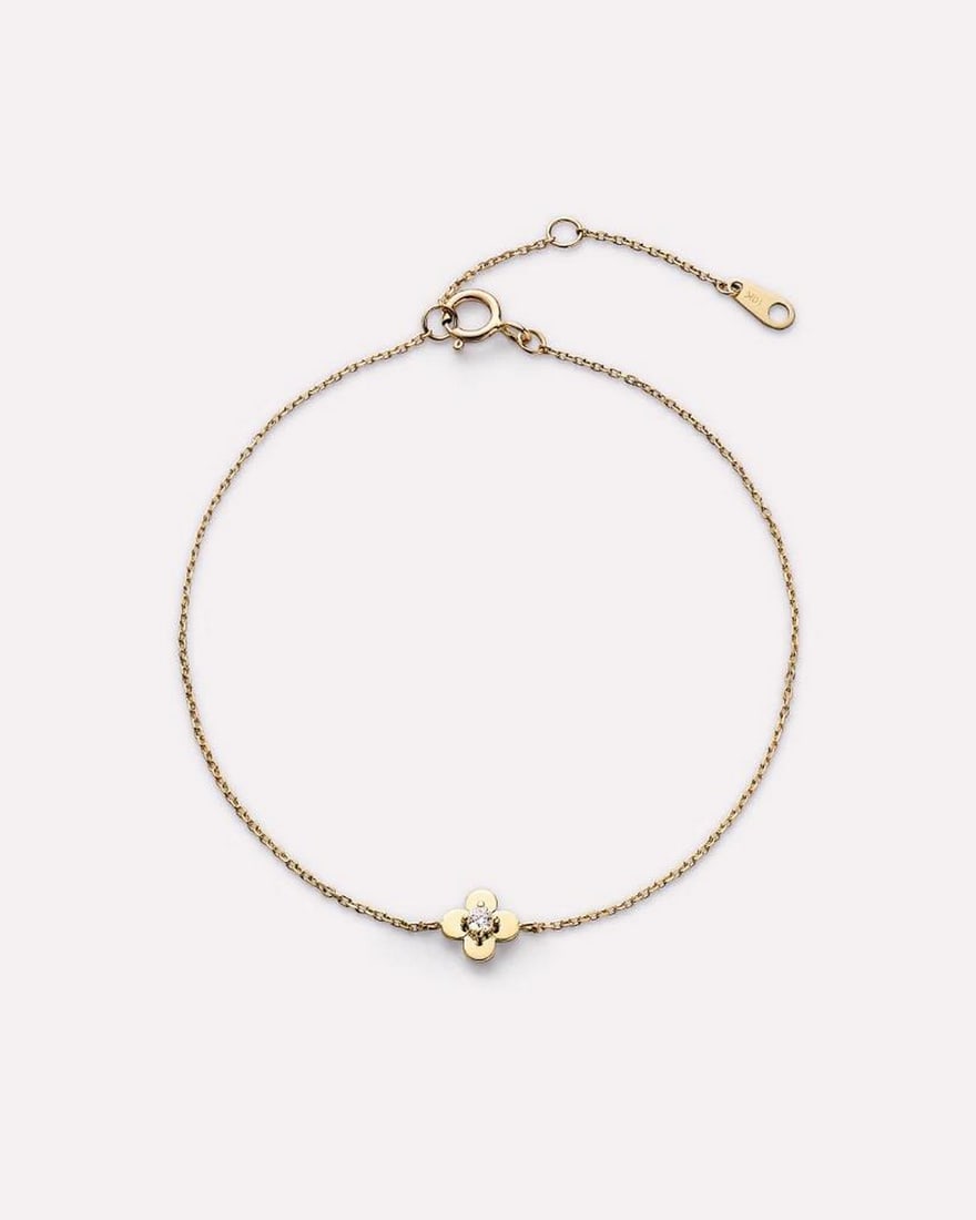 Solid Gold Flower Bracelet: Solid Gold Flower Bracelet This bracelet is crafted from recycled solid yellow gold and features a simple chain with a flower detail set with a lab-grown diamond. Designed for durability, it is