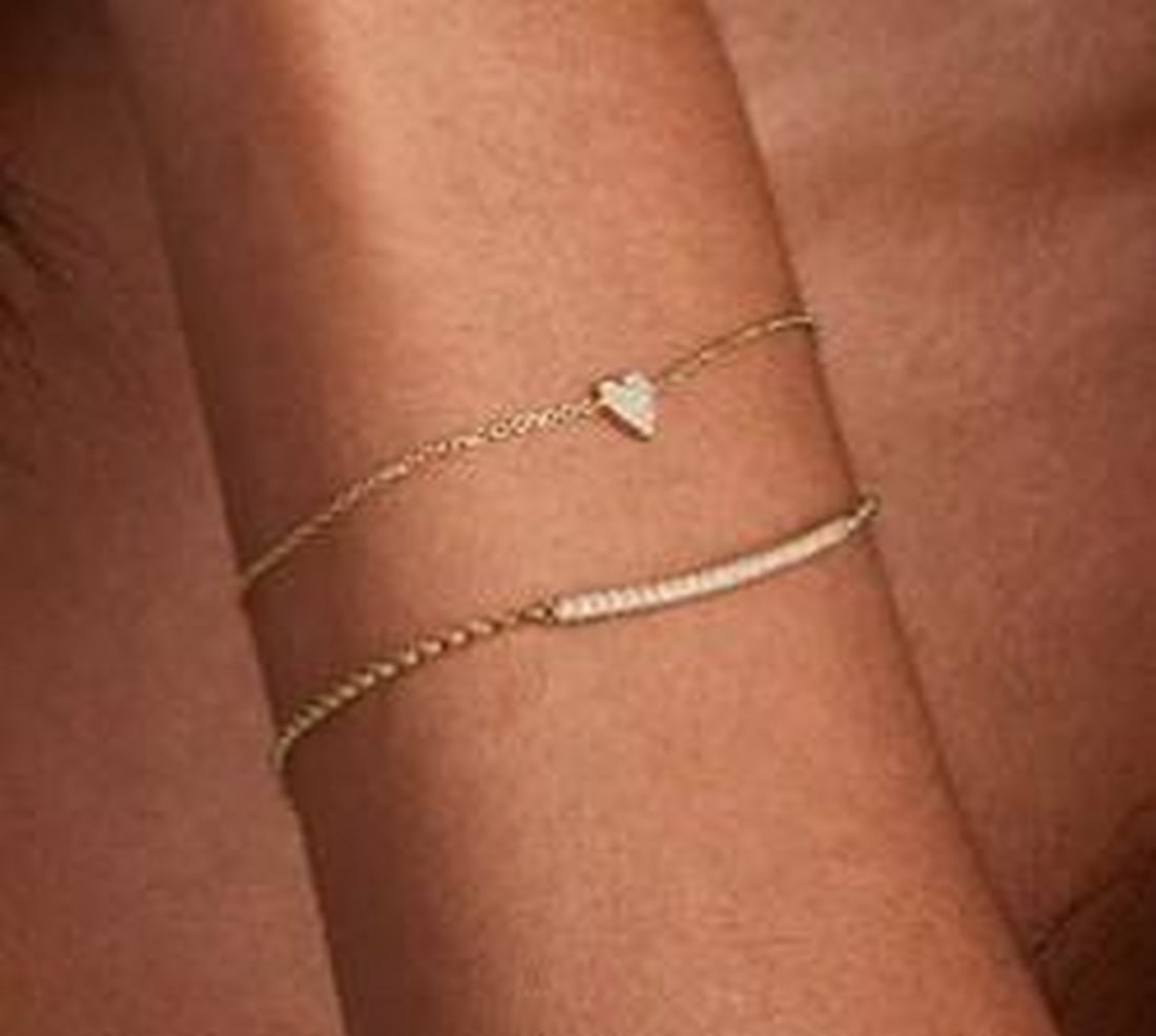 Whisper Heart Diamond Bracelet: Whisper Heart Diamond Bracelet A delicate symbol of love, this bracelet features a petite heart charm encrusted with shimmering pave-set diamonds. Suspended on a fine chain, the minimalist silhouette