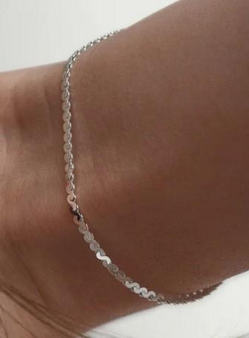 Sleek Serpentine Bracelet: Sleek Serpentine Bracelet Smooth and fluid, this serpentine chain bracelet glides around the wrist with a subtle shimmer. Crafted with tightly linked, wave-like curves, it reflects light beautifully