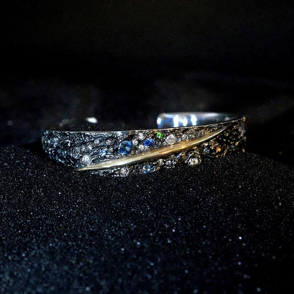 Meteorite and Fire Bangle: Meteorite and Fire Bangle Forged with fragments of real meteorite, the Meteorite and Fire Bangle bridges the cosmos and Mongolian tradition. Expertly handcrafted, it combines the raw, textured energy