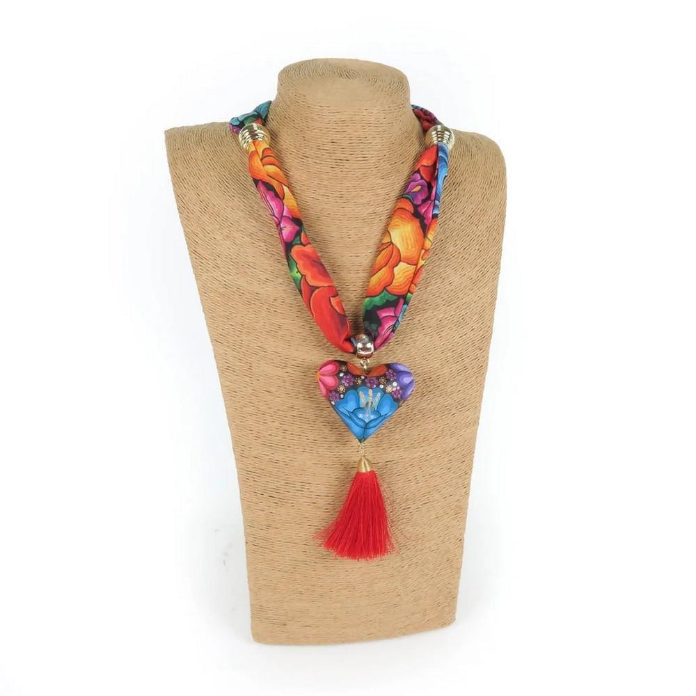 Oaxacan Alebrije Wood Carving Heart & Flowers Necklace: Oaxacan Alebrije Wood Carving Heart & Flowers Necklace Gorgeous heart necklace handcrafted from locally sourced copal wood, painted with colorful floral designs and traditional Zapotec patterns.
