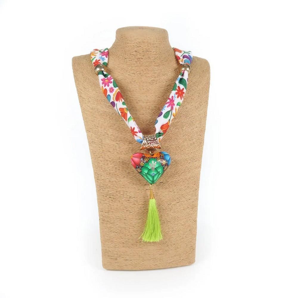 Oaxacan Alebrije Wood Carving Heart & Flowers Necklace: Oaxacan Alebrije Wood Carving Heart & Flowers Necklace This vibrant heart necklace is handcrafted from locally sourced copal wood and painted with colorful floral designs alongside traditional