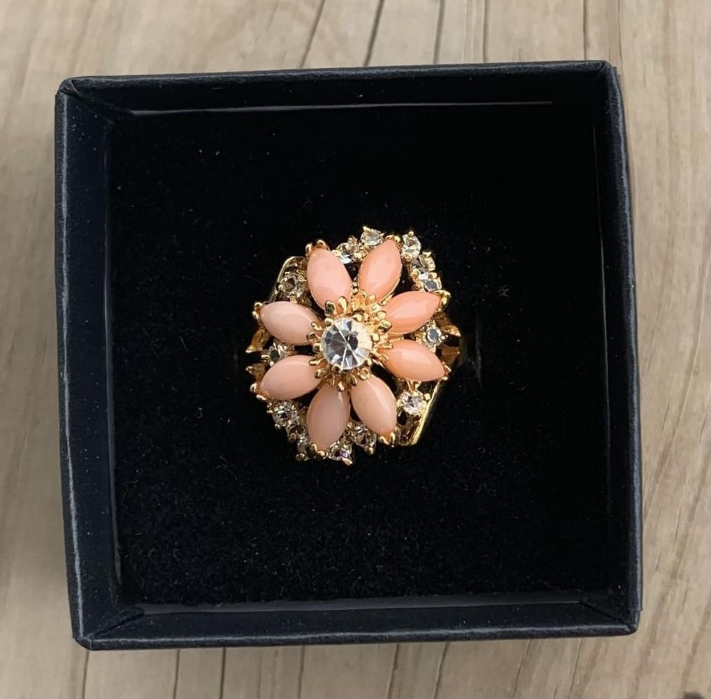 Coral Blossom Ring: Coral Blossom Ring Coral is often associated with being a symbol of wisdom, happiness, and immortality. The unique colour of coral is a mixture of pink and orange, pink being a symbol of femininity