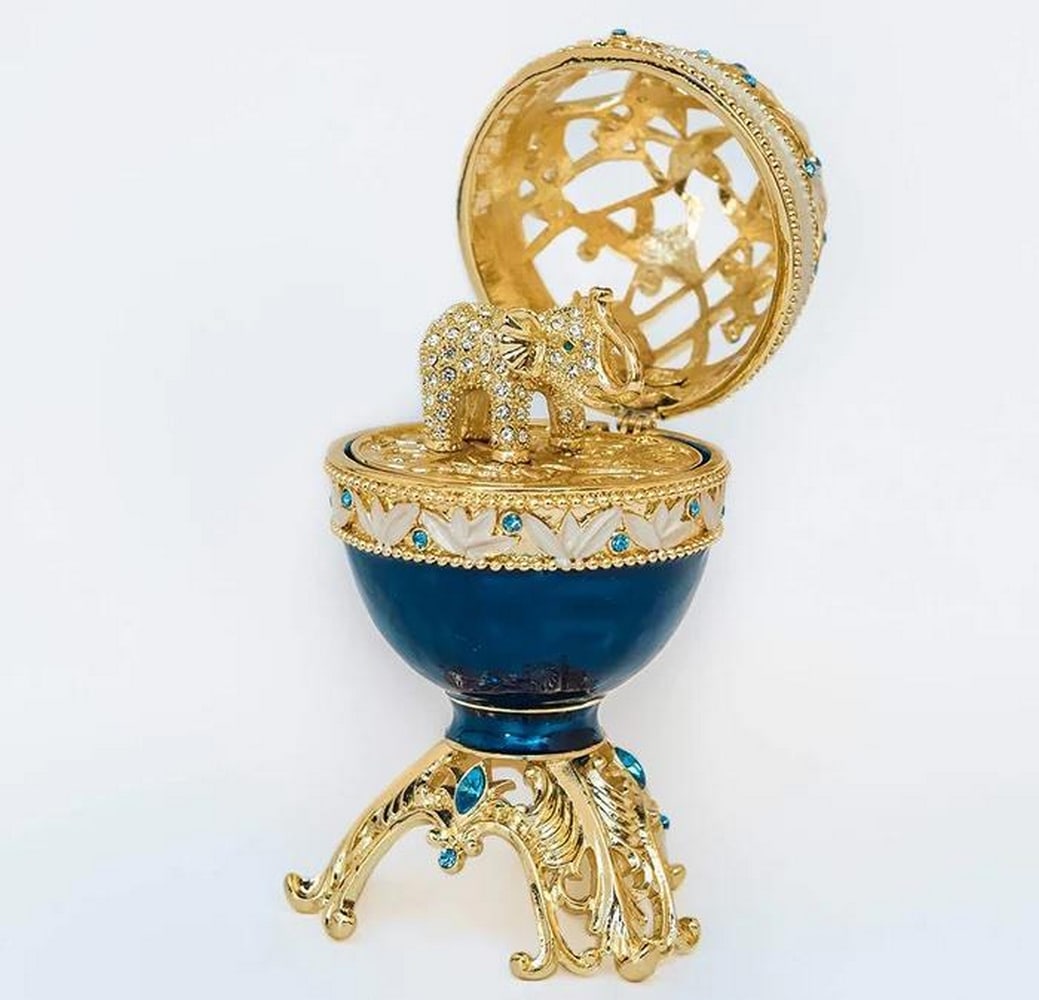 Regal Azure Fabergé Egg Featuring a Majestic Golden Elephant: Regal Azure Fabergé Egg Featuring a Majestic Golden Elephant Immerse yourself in the epitome of elegance with our Regal Azure Fabergé Egg Featuring a Majestic Golden Elephant—a radiant fusion of