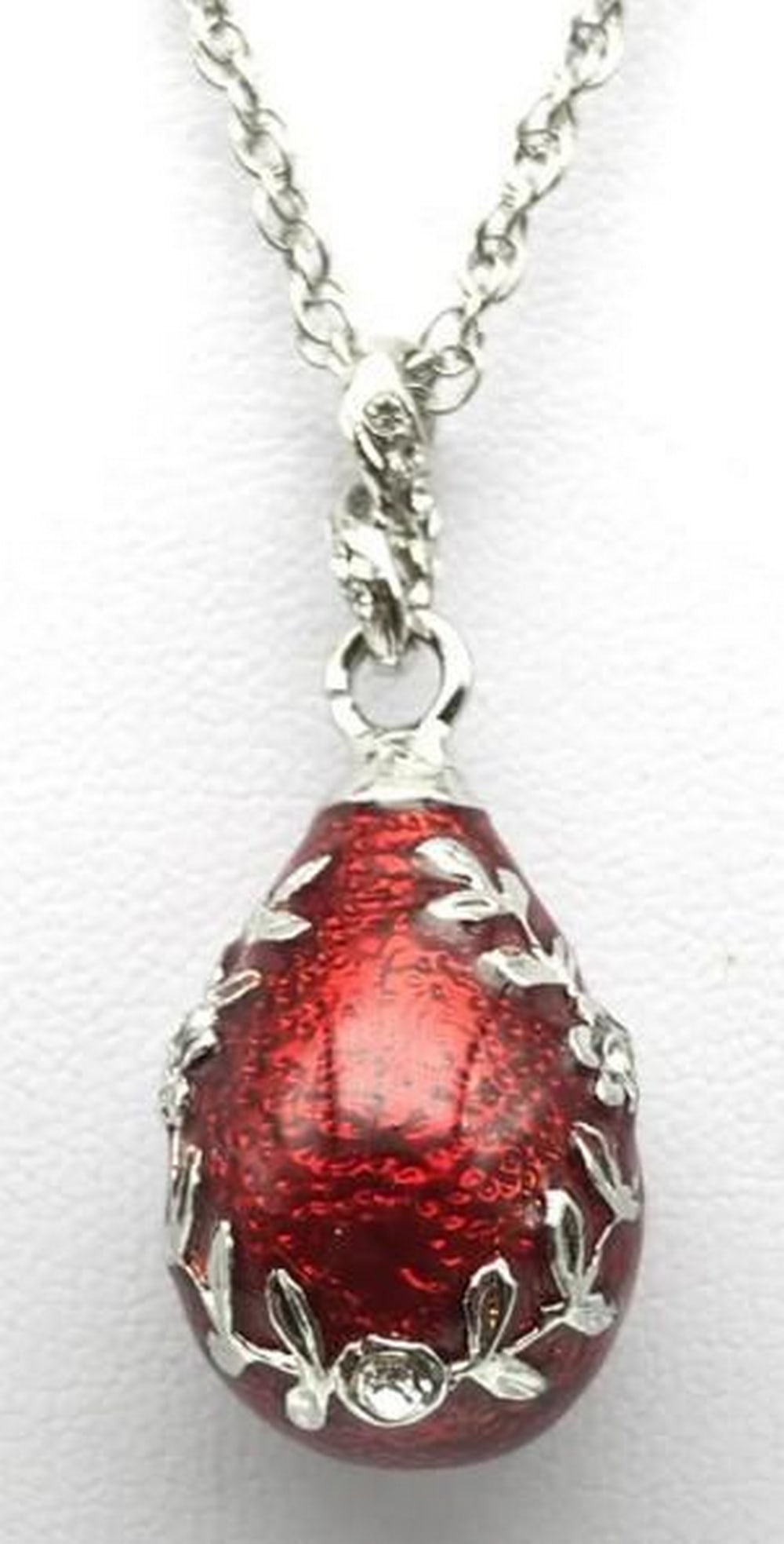 Crimson Glow Egg Pendant Necklace: Crimson Glow Egg Pendant Necklace This striking red egg pendant necklace captures attention with its rich, vibrant hue and smooth polished finish. Suspended from a delicate chain, the elegant design