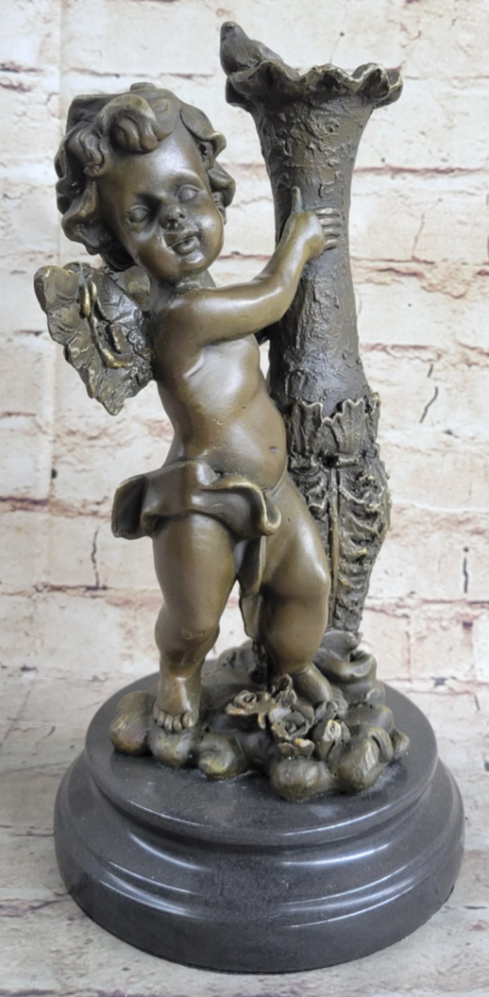 Cherub Angel Bronze Statue: Cherub Angel Bronze Statue The cherubic angel seems to have just landed from great heights among the ruins of an old enchanted garden. He holds himself steady from the fall to earth against a forgotte