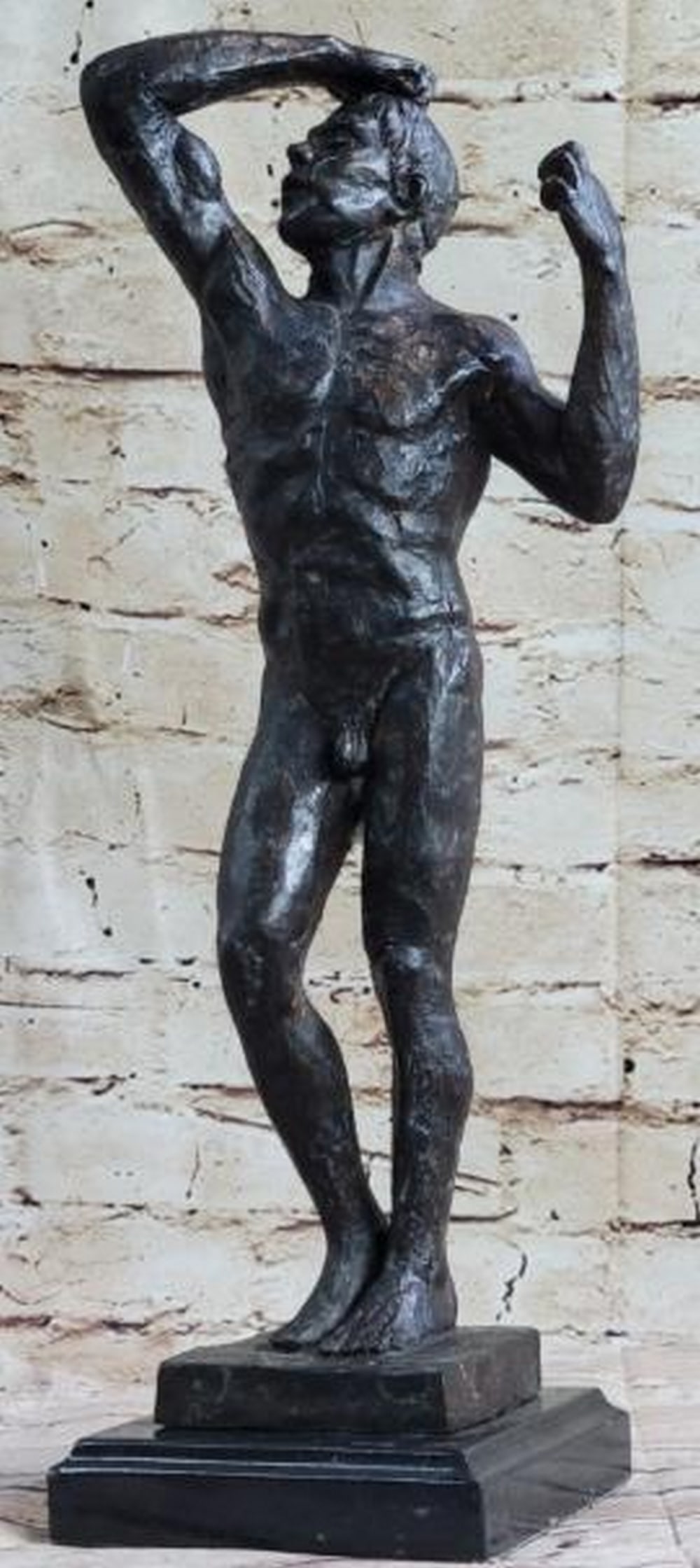 Tension in Bronze: Tension in Bronze This evocative reproduction bronze sculpture depicts a nude man frozen in a moment of intense physical and emotional strain. Standing upright, his right hand is clenched and pressed 