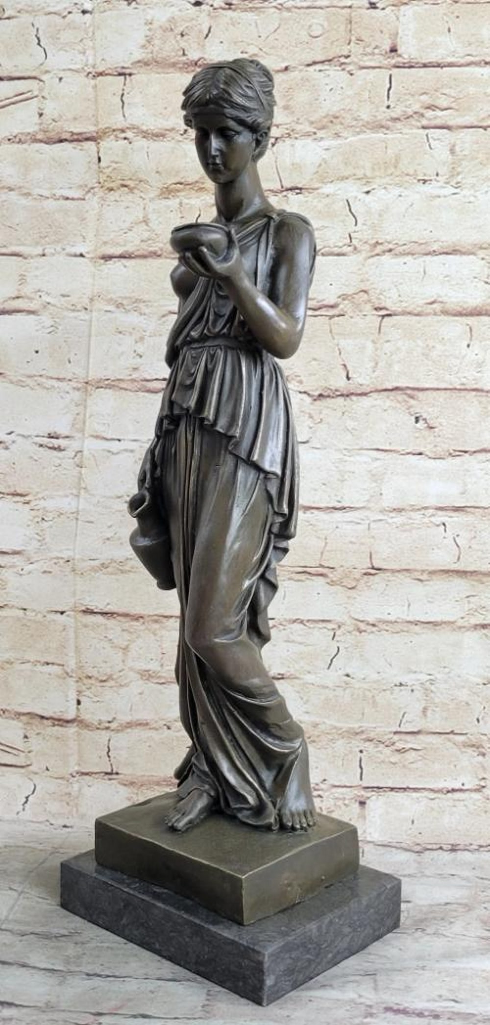 Inspired Bronze Young Lady Offering Water Sculpture - 20" x 6.5": Inspired Bronze Young Lady Offering Water Sculpture - 20" x 6.5" This elegant bronze sculpture by Milo portrays a young woman in a moment of quiet service, offering water with a jug and bowl i