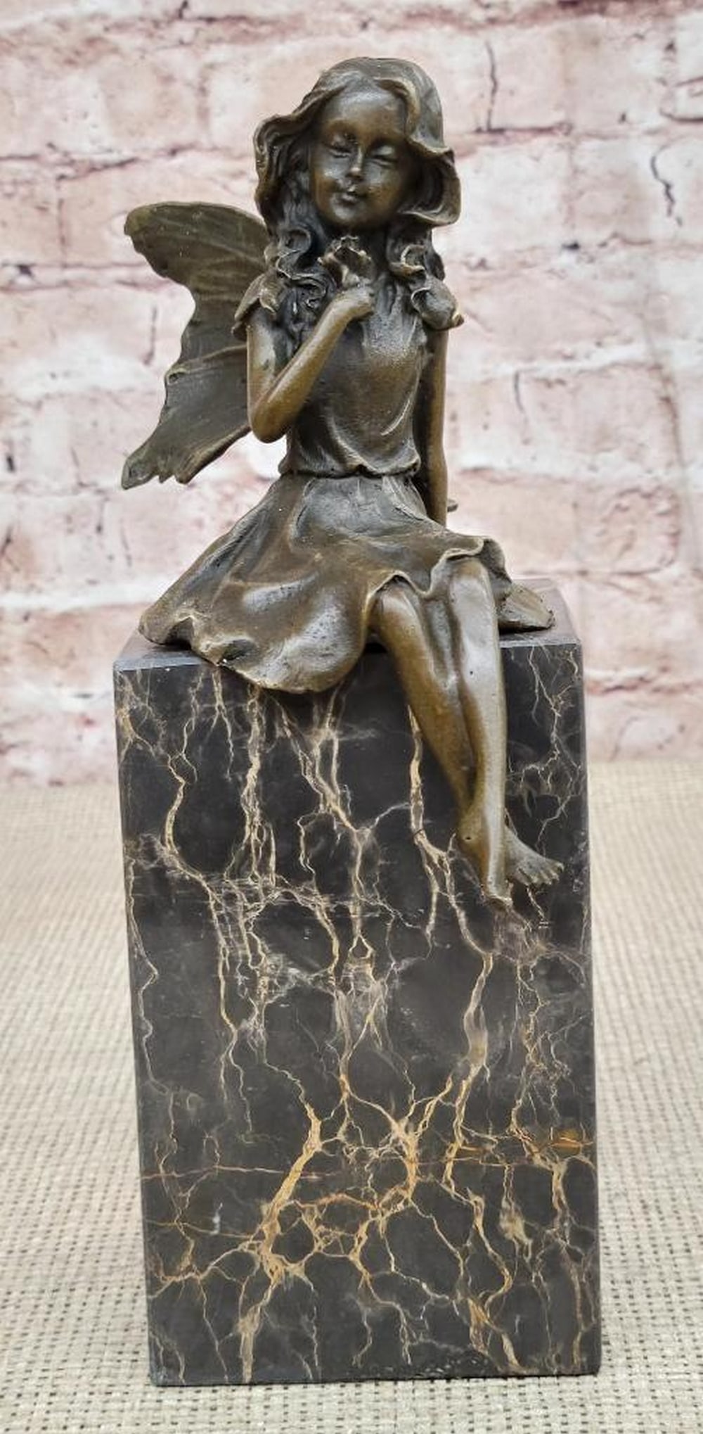 Fairy Holding Rose Original Bronze Statue - 9" x 8": Fairy Holding Rose Original Bronze Statue - 9" x 8" This enchanting bronze sculpture captures the essence of daydreaming with a whimsical fairy seated gracefully on a rock, gazing wistfully in