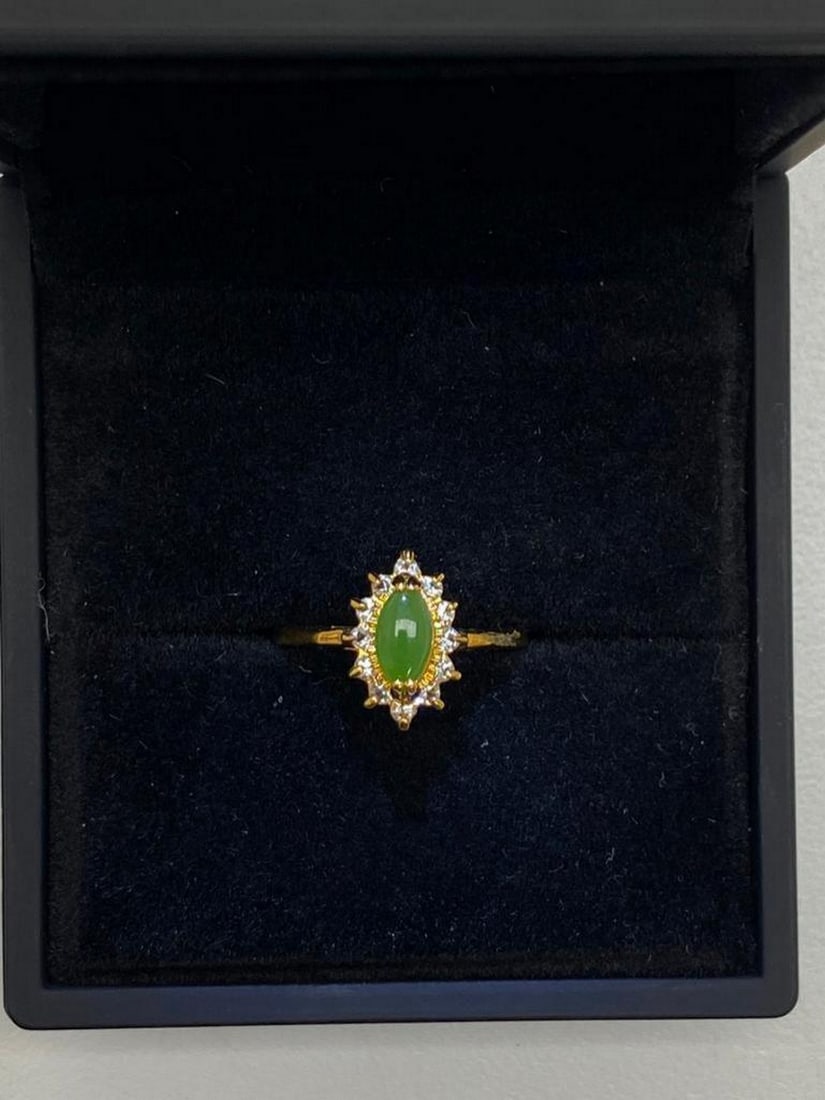 One of a Kind Jade and Austrian Crystal Gemstone Ring?: One of a Kind Jade and Austrian Crystal Gemstone Ring. Distinctive and unique green Jade stone surrounded by Austrian crystals on a 18KTGP Band.Green Jade is believed to improve kidney and heart funct
