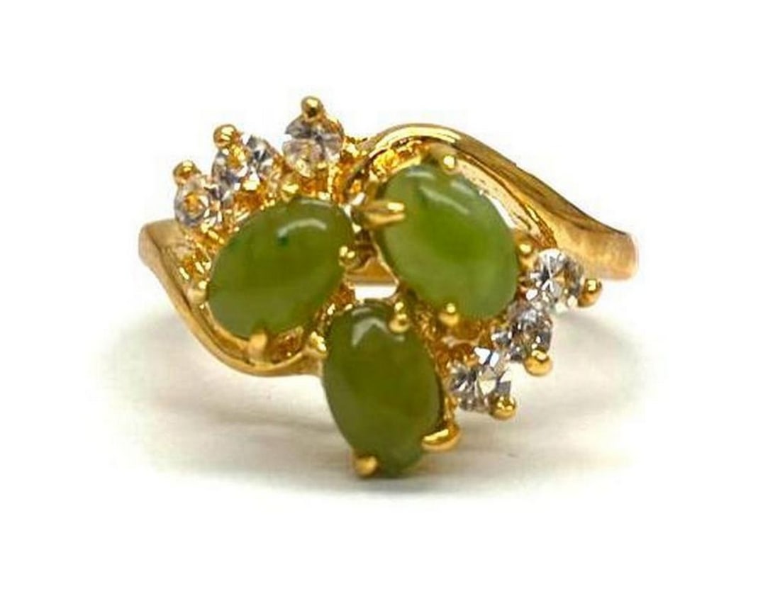 Triple Jade Harmony Austrian Crystal 18KTGP Ring Size 6: Triple Jade Harmony Austrian Crystal 18KTGP Ring Size 6 Distinctive and unique green Jade stone surrounded by Austrian crystals on a 18KTGP Band.Green Jade is believed to improve kidney and heart func
