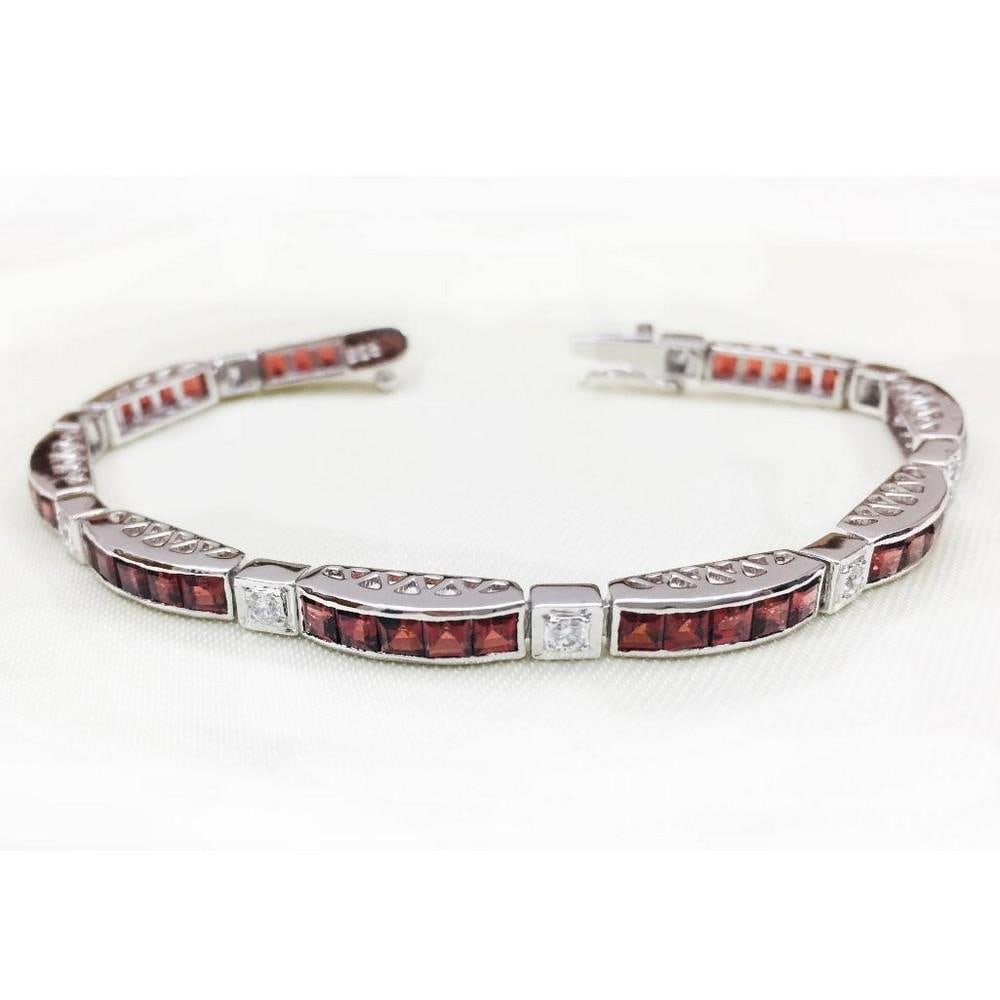 Garnet Blocks Studded 925 Sterling Silver Bracelet: Garnet Blocks Studded 925 Sterling Silver Bracelet This bracelet is 925 Sterling Silver and features square faceted garnet stones with sqaures of zirconia in between. Size of Gemstones: 3x3mm View Pho