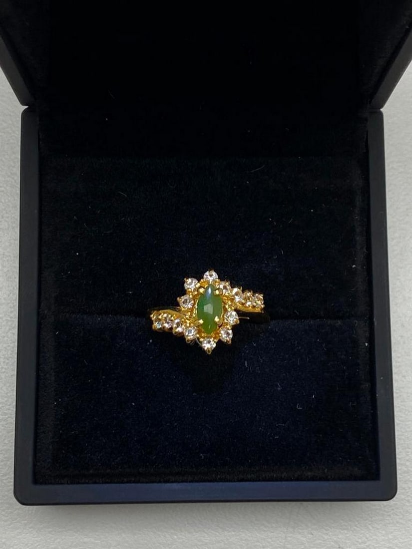 One of a Kind Jade and Austrian Crystal Gemstone Ring: One of a Kind Jade and Austrian Crystal Gemstone Ring. Distinctive and unique green Jade stone surrounded by Austrian crystals on a 18KTGP Band.Green Jade is believed to improve kidney and heart