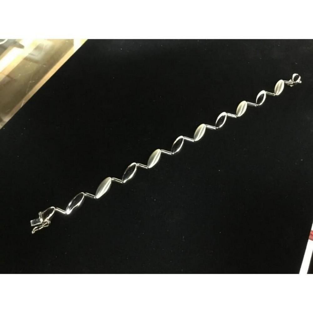 Custom Designed 14K White Gold Brilliance Woman's Bracelet: A Custom Designed 14K White Gold Brilliance Woman's Bracelet that has a look to its own. Adding a little flavor to your style with this 14K White Gold Bracelet can spice things up in a hurry. Italian 