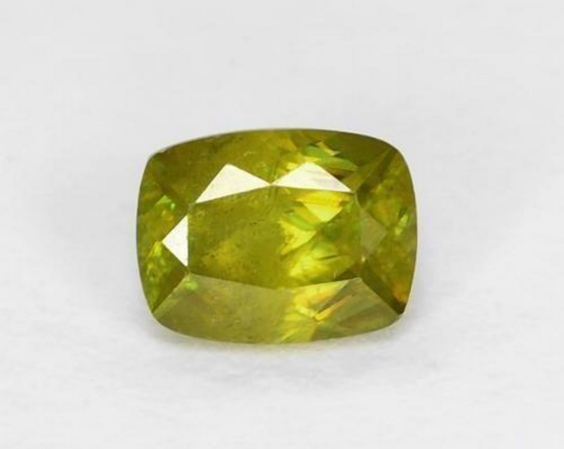 0.54 ct Natural Warm Forest Green Sphene, Cushion Cut, VS, Sri Lanka: 0.54 ct Natural Warm Forest Green Sphene, Cushion Cut, VS, Sri Lanka Natural sphene gemstone weighing 0.54 ct, cut in a classic cushion facet shape with a warm forest green color. The gem measures
