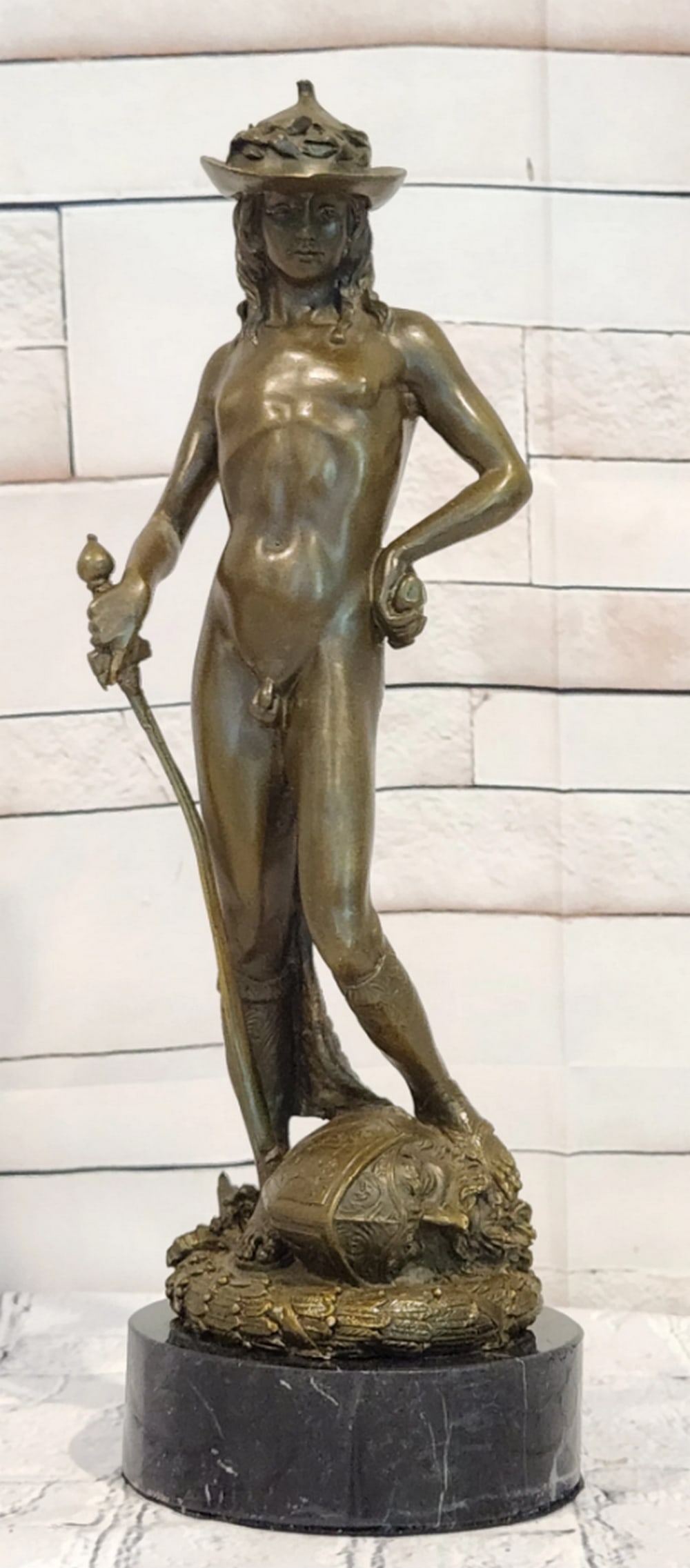 David Bronze Sculpture by Miguel Lopez - 12" x 4": David Bronze Sculpture by Miguel Lopez - 12" x 4" Introducing a Classical Bronze Sculpture: This depiction of David is meticulously handcrafted with careful attention to detail. The figure is 