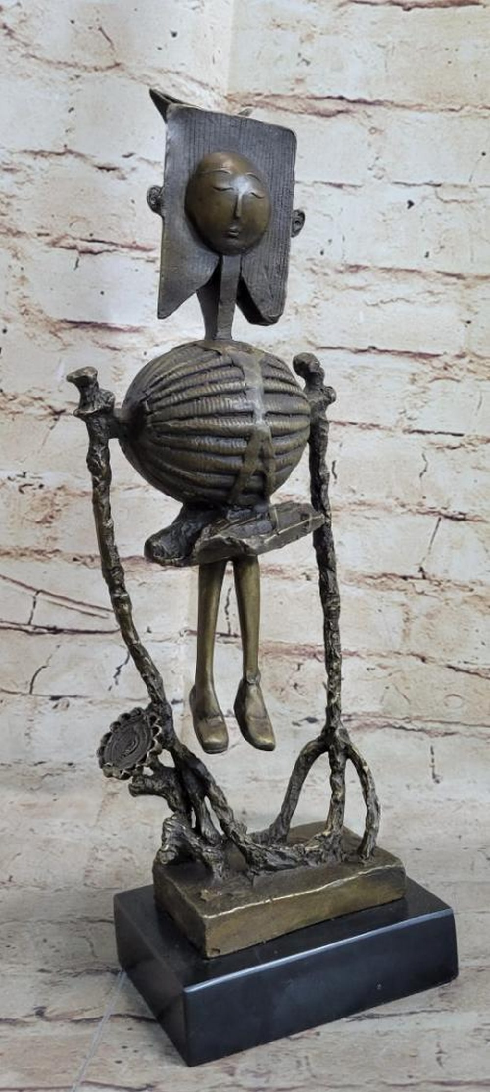 Robot Skeleton Bronze Statue Sculpture: Robot Skeleton Bronze Statue Sculpture This abstract sculpture is a great conversation piece. There is profile of a person is smoothly carved onto a stone rock. The contradicting style of the smooth, 