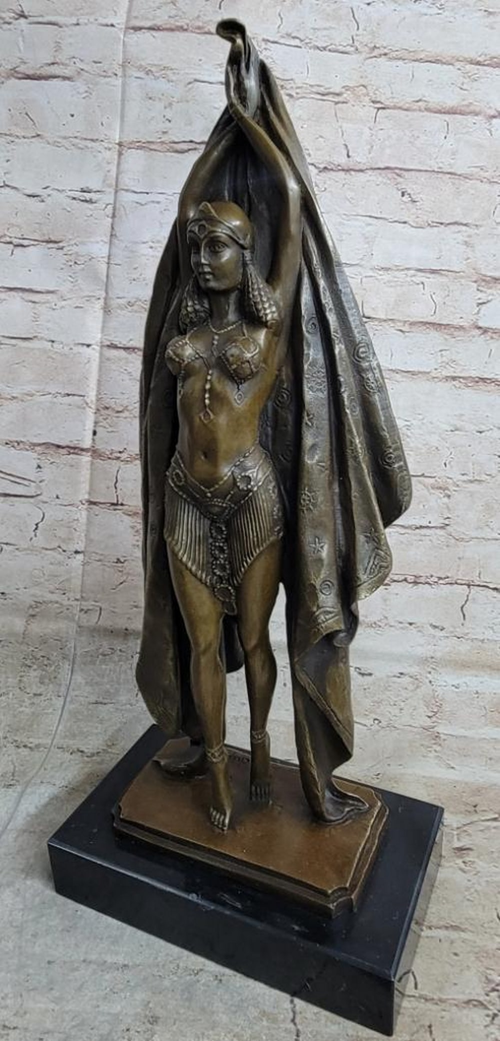 Russian Dancer Inspired Bronze Statue - 18" x 8": Russian Dancer Inspired Bronze Statue - 18" x 8" Behold the formidable female warrior in bronze. She stands tall in a studded bra top and angled skirt, exuding confidence and strength. With ha
