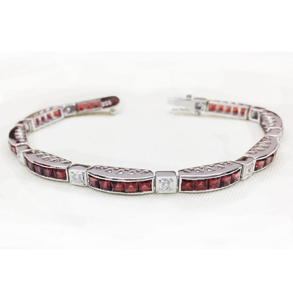 Garnet Blocks Studded 925 Sterling Silver Bracelet: Garnet Blocks Studded 925 Sterling Silver Bracelet This bracelet is 925 Sterling Silver and features square faceted garnet stones with sqaures of zirconia in between. Size of Gemstones: 3x3mm View