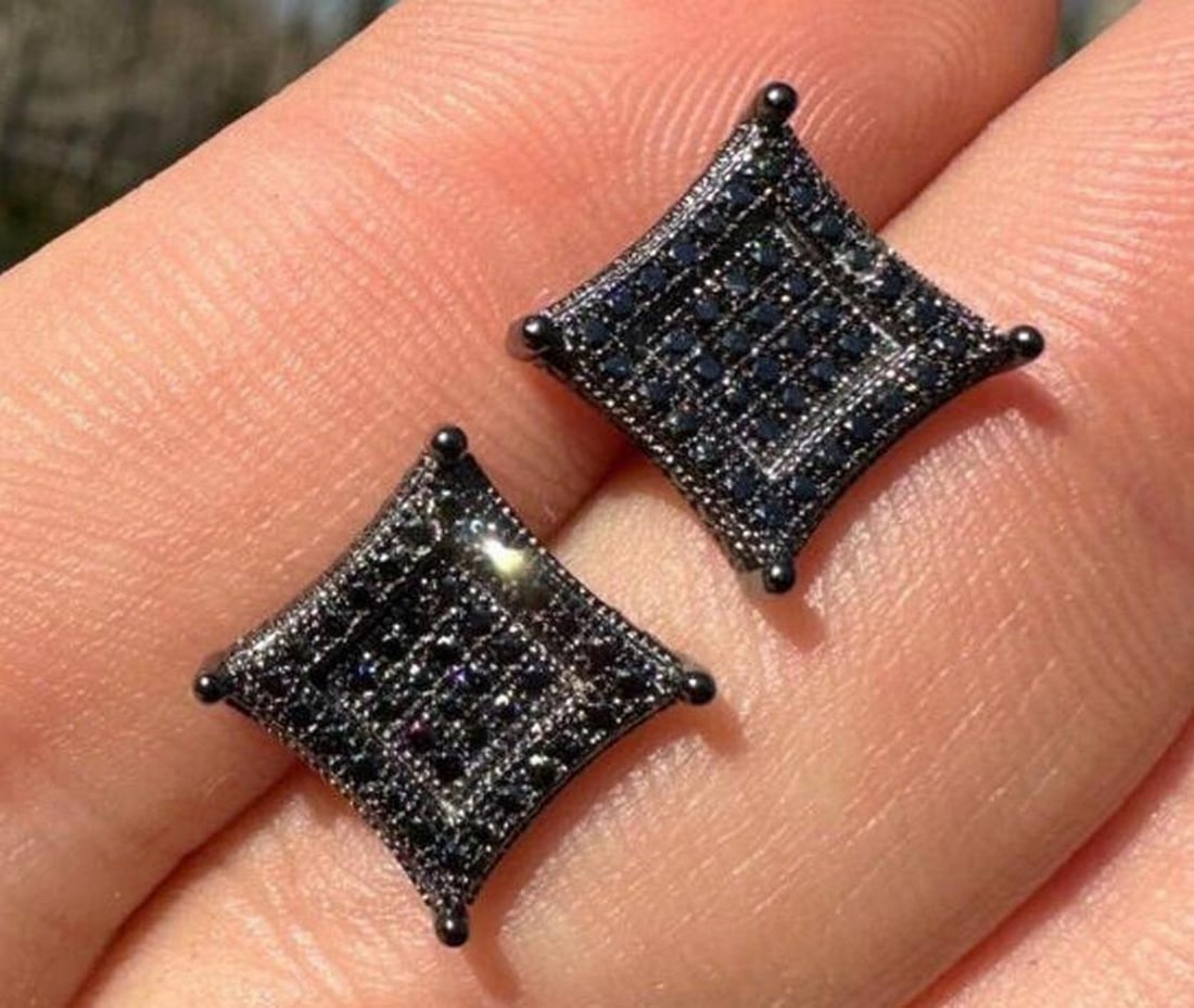 Black Moissanite Rhodium 925 Sterling Silver Stud Earrings: Black Moissanite Rhodium 925 Sterling Silver Stud Earrings The central focus of these stud earrings is the enchanting black moissanite stones, meticulously cut to perfection to capture and reflect