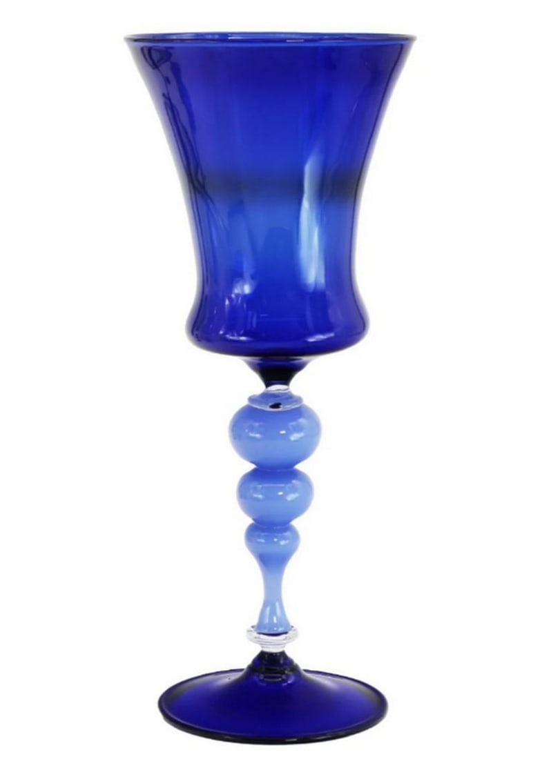 Venetian Goblet “Blue Flute?? – Murano Glass with Worm Modeling: Venetian Goblet “Blue Flute” – Murano Glass with Worm Modeling Experience the elegance of Murano craftsmanship with the Blue Flute Venetian Goblet, a hand-blown piece in vibrant blue glass