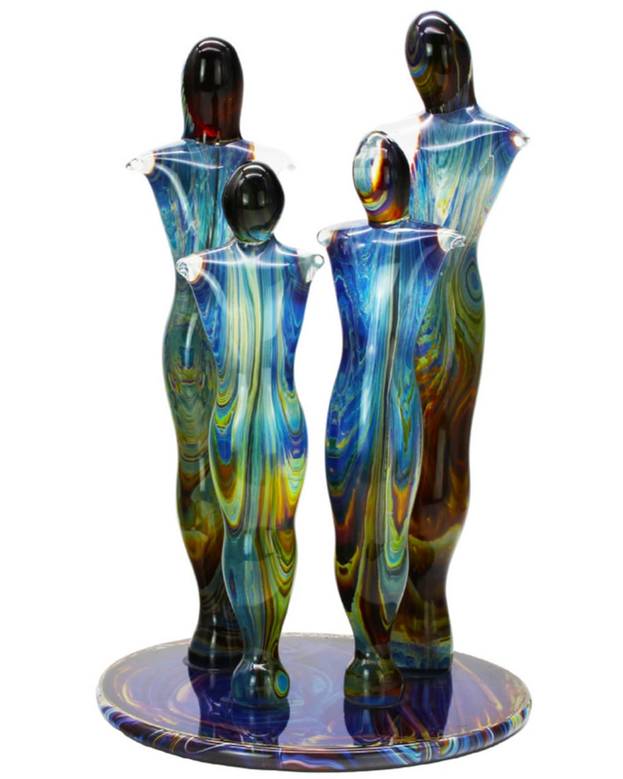 Murano Chalcedony and Glass Family Sculpture: Murano Chalcedony and Glass Family Sculpture This artwork, crafted in clear and chalcedony glass, is shaped entirely by hand from solid glass. Chalcedony glass, known for its complexity, merges the tr