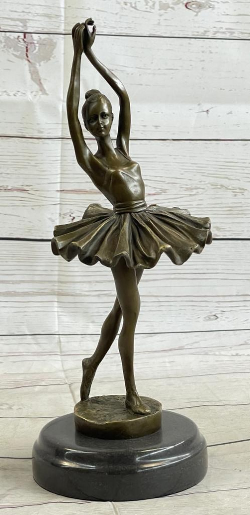 Performing Ballerina Original Bronze Statue - 12" x 5": Performing Ballerina Original Bronze Statue - 12" x 5" Celebrate the elegance of ballet with this exquisite bronze sculpture of a ballerina. Poised and graceful, she gazes adoringly toward the