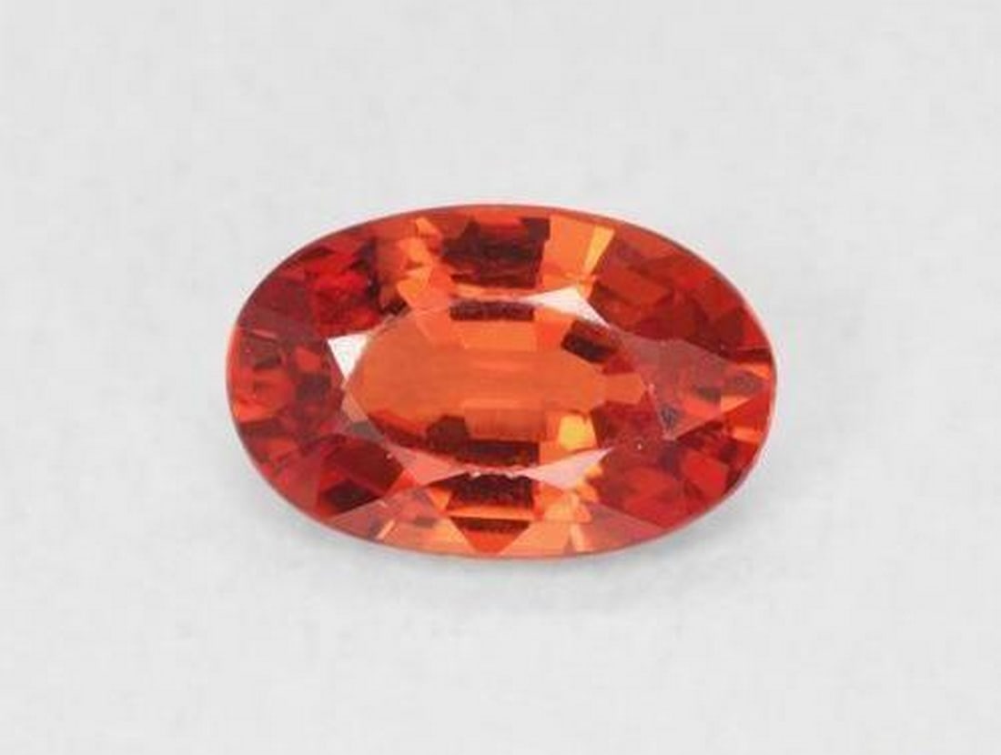 0.54 ct Oval Natural Medium Red Sapphire: 0.54 ct Oval Natural Medium Red Sapphire Introducing the Oval Natural Medium Red Sapphire, a vibrant gem with a rich medium red hue and excellent clarity. This oval-faceted sapphire from Tanzania is h