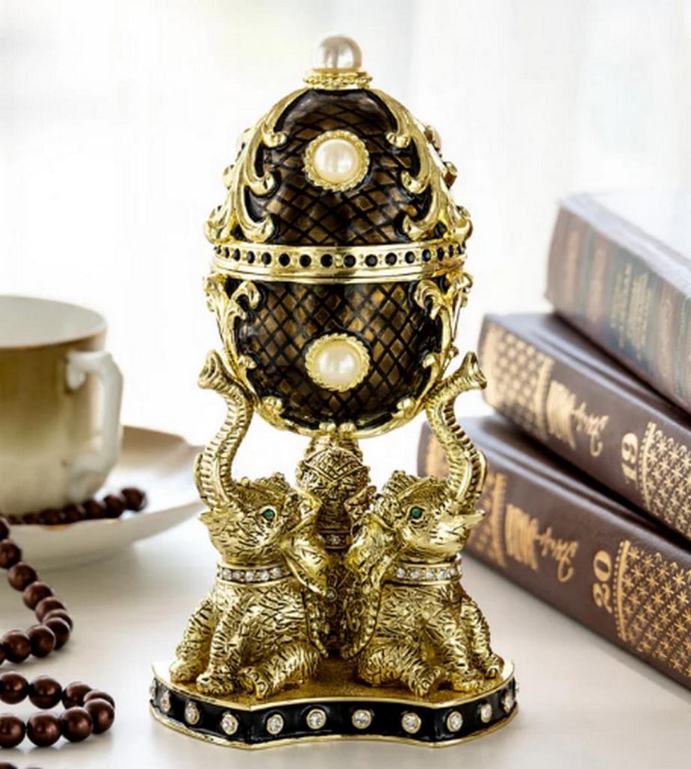 Regal Brown & Gold Enamel Egg Trinket Box on Elephant Pedestal: Regal Brown & Gold Enamel Egg Trinket Box on Elephant Pedestal This regal trinket box features a stunning deep brown and gold enameled egg, accented with lustrous pearls and intricate gold