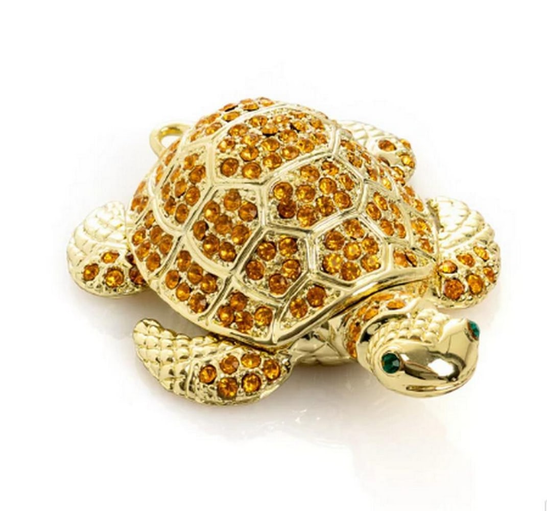Golden Turtle Enamel Jewelry Box: Golden Turtle Enamel Jewelry Box Delight in the charm of this Golden Turtle enamel jewelry box, exquisitely handcrafted and adorned with handpicked Austrian crystals. Plated in 24K gold or 925